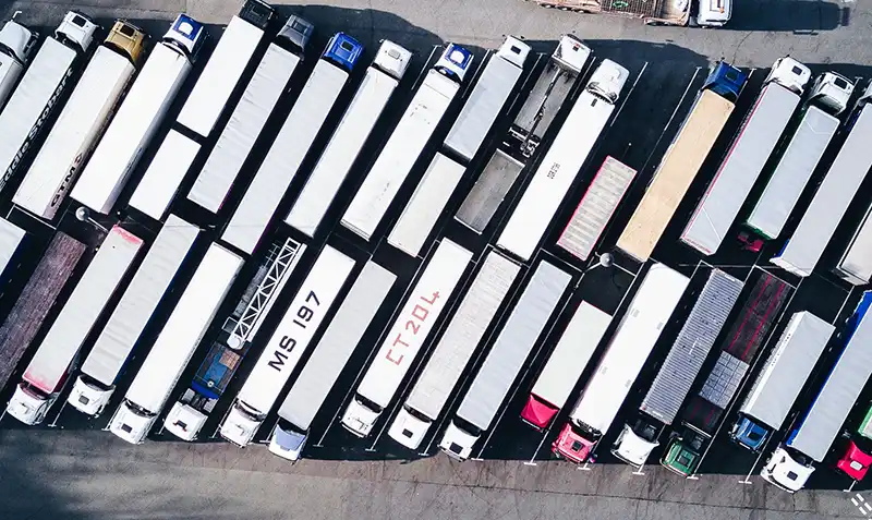 Semi trucks cargo trailers side by side